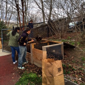 High school students turning compost.